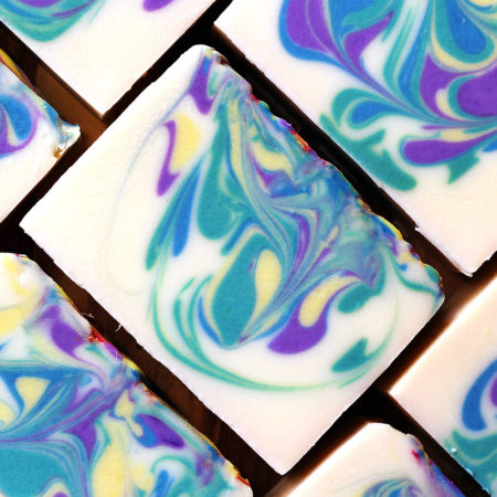Brightly swirled bars of soap, white, with blue, green, purple, yellow and pink.