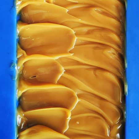 Caramel coloured soap in a mould.