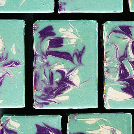 Green soap bars, with purple and white swirled through them.