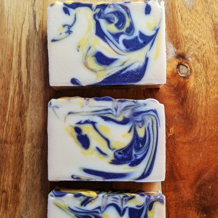 White bars of soap with purple and yellow swirls through them.