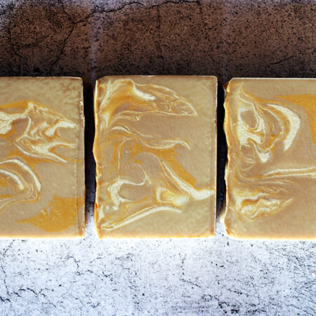 Creamy brown bars of soap with lighter brown and gold swirling throughout.