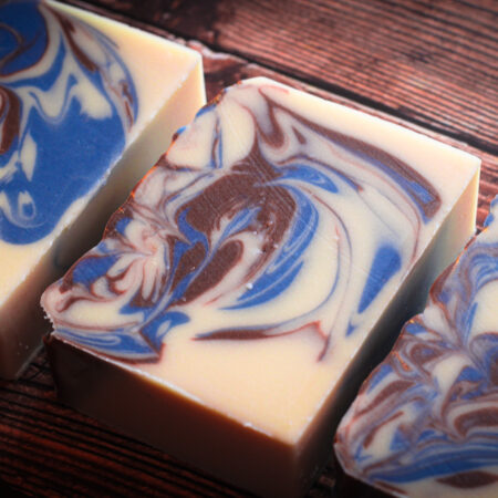 Bars of creamy white soap, swirled through with metallic brown and blue swirls.