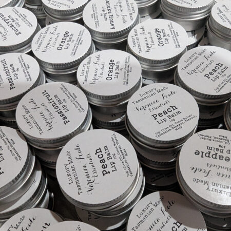 Many small tins with black and white labels. They're lip balms, with assorted flavours.